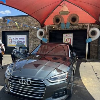 Grey Audi A5 convertible freshly washed under the HeadLampChamp canopy