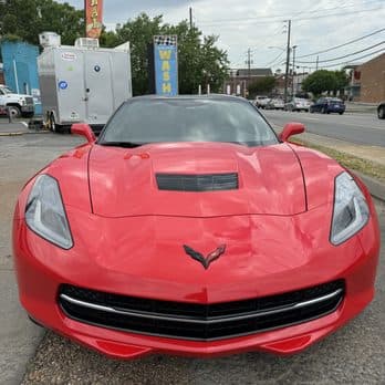Freshly detailed red Chevrolet Corvette outside HeadLampChamp in Cartersville